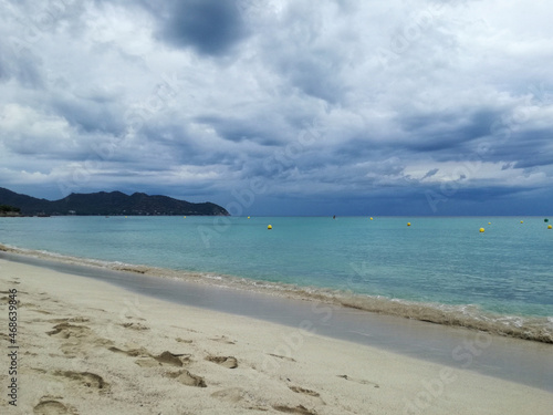 beach in mallorca, spain. a cloudy day, in the background there is a mountain
