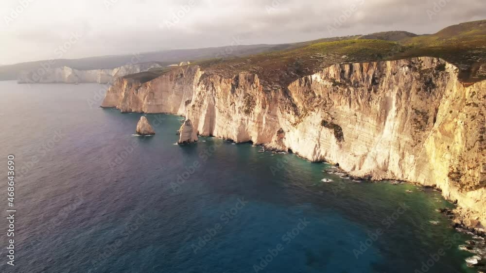 Aerial drone view of the Ionian Sea coast of Zakynthos, Greece. Rocky cliffs, vegetation, blue water. Sunset Aerial drone view of the Ionian Sea coast of Zakynthos, Greece. Rocky cliffs, vegetation, blue water. Sunset