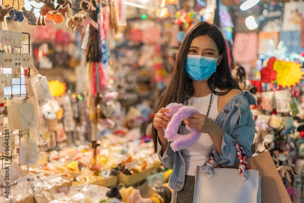 Asian woman shopping in a random night market in Bangkok, Thailand
