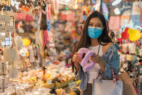 Asian woman shopping in a random night market in Bangkok, Thailand 