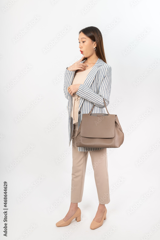 Photograph of a young asian office lady in her office outfit with a bag, focus on different mood and expression