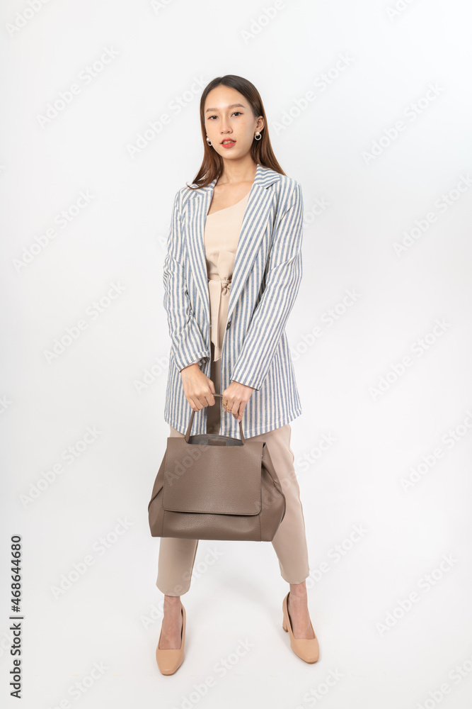 Photograph of a young asian office lady in her office outfit with a bag, focus on different mood and expression Photograph of a young asian office lady in her office outfit with a bag, focus on different mood and expression