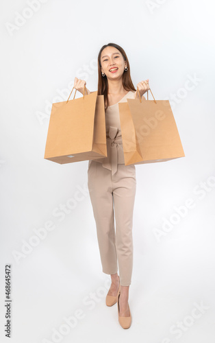 A series of photo collection focusing on the moments, expression and gestures of an asian office lady with brown shopping bag that also look like delivery bag. All are full body, high resolution shots © asean studio
