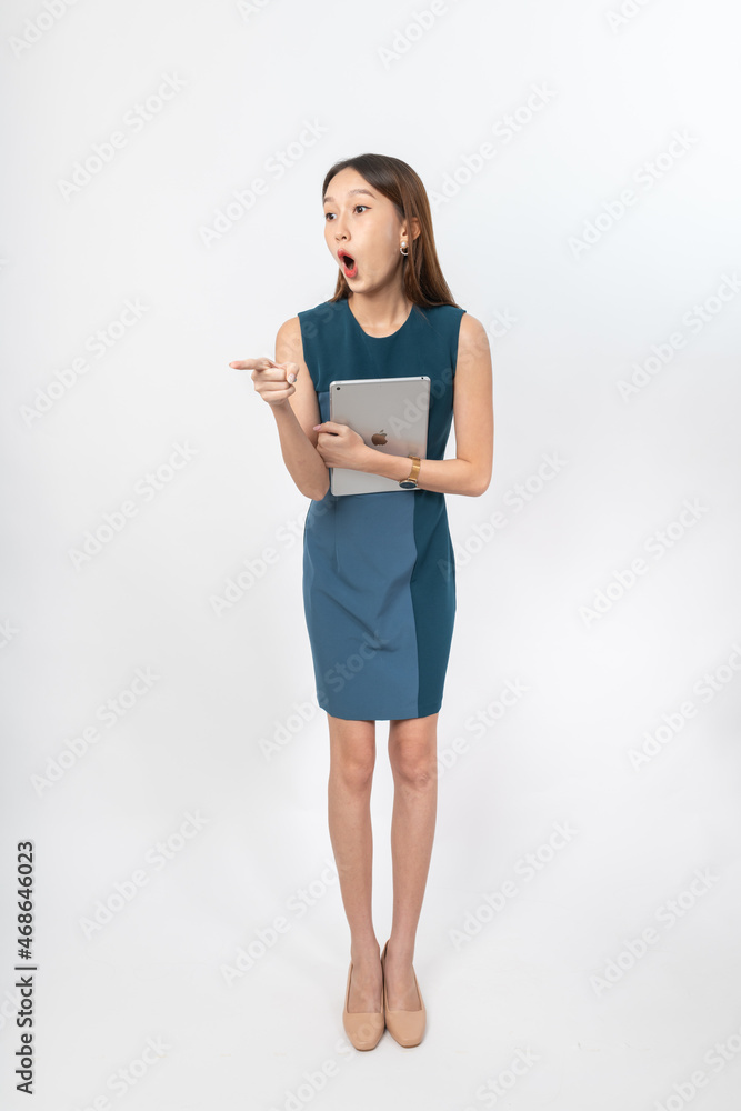 Photograph of a young, beautiful and sexy asian Thai lady model in professional business attire with a tablet on hand Photograph of a young, beautiful and sexy asian Thai lady model in professional business attire with a tablet on hand