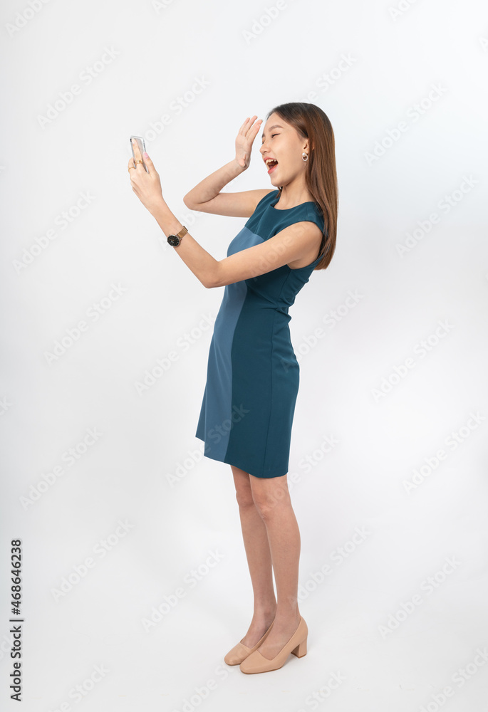 Photograph of a young, beautiful and sexy asian Thai lady model in professional business attire with a mobile phone on hand Photograph of a young, beautiful and sexy asian Thai lady model in professional business attire with a mobile phone on hand