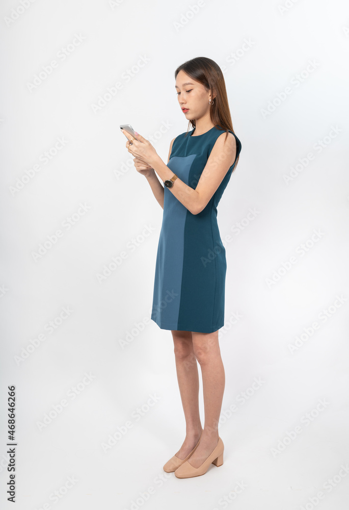 Photograph of a young, beautiful and sexy asian Thai lady model in professional business attire with a mobile phone on hand Photograph of a young, beautiful and sexy asian Thai lady model in professional business attire with a mobile phone on hand
