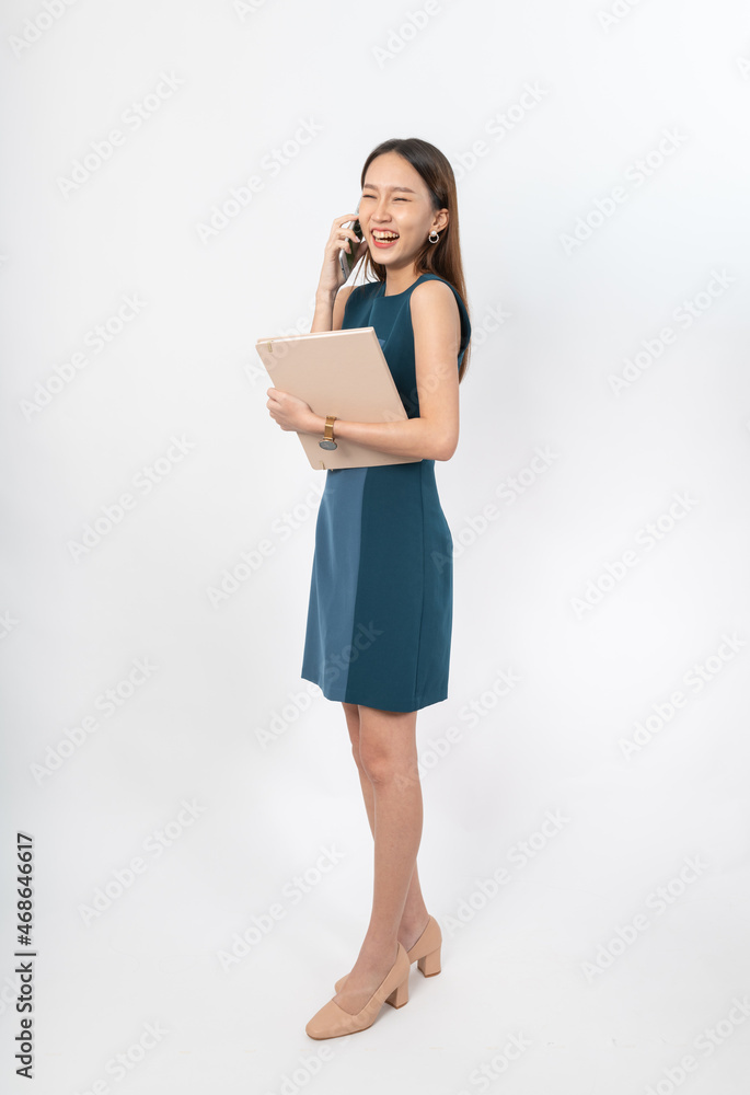Photograph of a young, beautiful and sexy asian Thai lady model in professional business attire with a mobile phone and notebook on hand Photograph of a young, beautiful and sexy asian Thai lady model in professional business attire with a mobile phone and notebook on hand