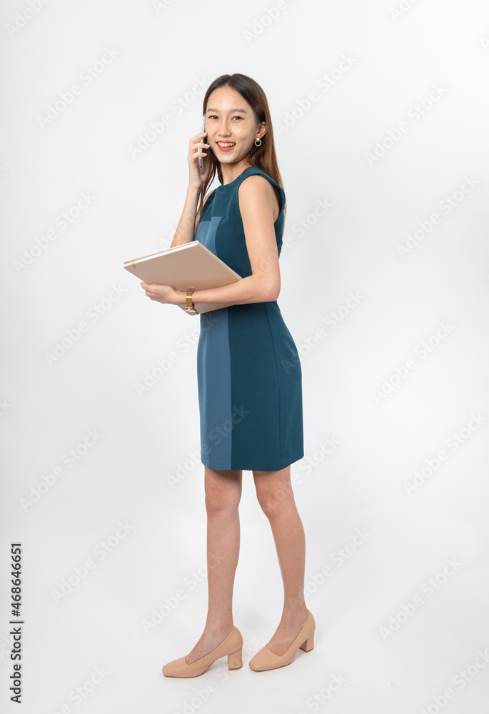 Photograph of a young, beautiful and sexy asian Thai lady model in professional business attire with a mobile phone and notebook on hand Photograph of a young, beautiful and sexy asian Thai lady model in professional business attire with a mobile phone and notebook on hand
