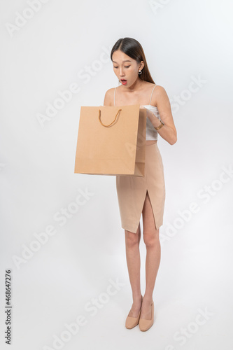 Young Asian Business Office Lady with brown paper shopping bag on white background © asean studio