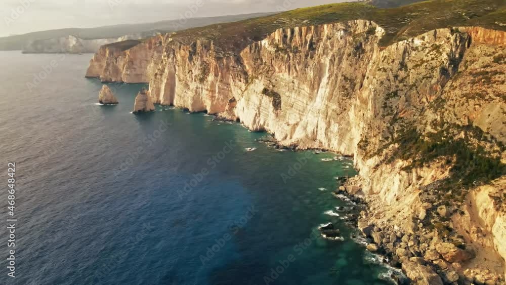 Aerial drone view of the Ionian Sea coast of Zakynthos, Greece. Rocky cliffs, vegetation, blue water. Sunset Aerial drone view of the Ionian Sea coast of Zakynthos, Greece. Rocky cliffs, vegetation, blue water. Sunset