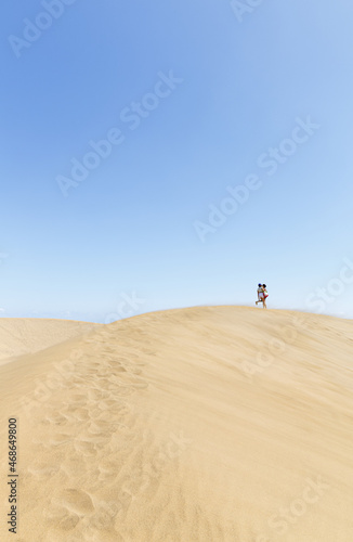 girls walking in dunes