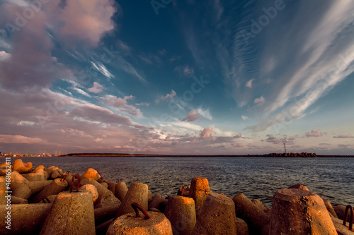 Beautiful sunset view of the port aquatory and boulders for strengthening. Klaipeda, Lithuania photo