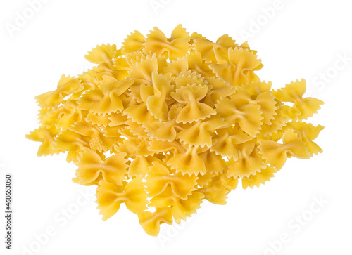 Heap of dry eggless farfalle pasta isolated on a white background. Closeup of spilled yellow bow-tie pastas pile from wheat semolina. Butterfly shaped meal with saccharides, starch and gluten content.