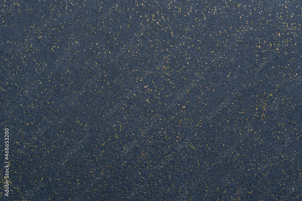 A sheet of navy blue decorative interlining with golden glitter dots. Non-woven fabric as a background. Star galaxy universe concept A sheet of navy blue decorative interlining with golden glitter dots. Non-woven fabric as a background. Star galaxy universe concept