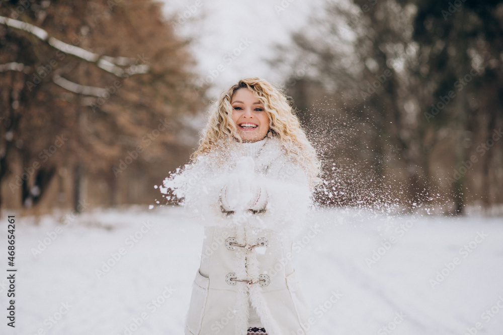 Young woman with curly hair walking in a winter park Young woman with curly hair walking in a winter park