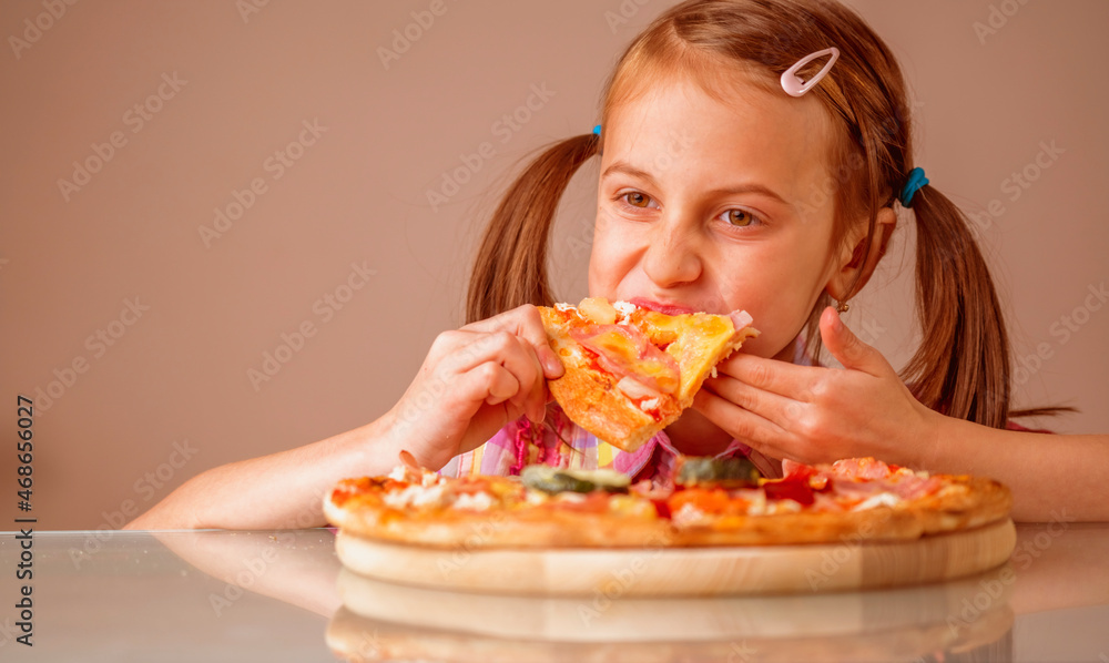 Young beautiful attractive girl enjoys delicious slice of pizza. Copy space.