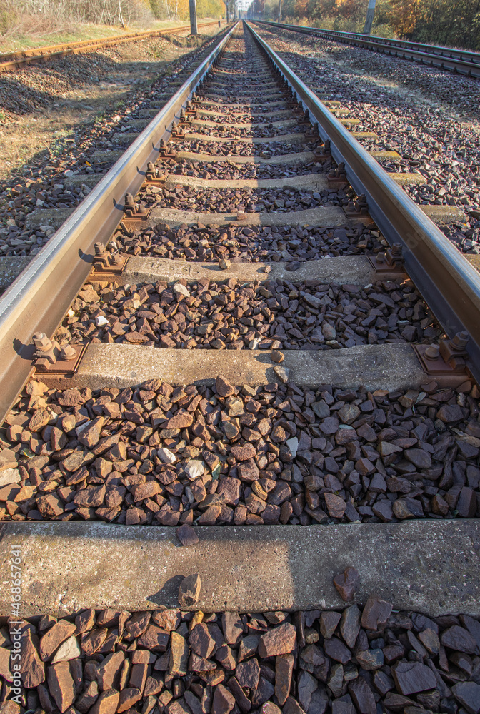 Naklejka premium view of the rails from a low perspective, close-up of the rails and railway sleepers.
