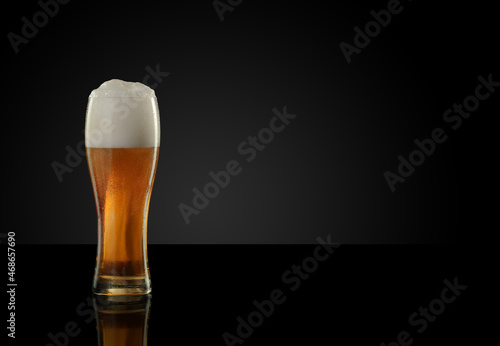 mug full of beer with foam and bubbles