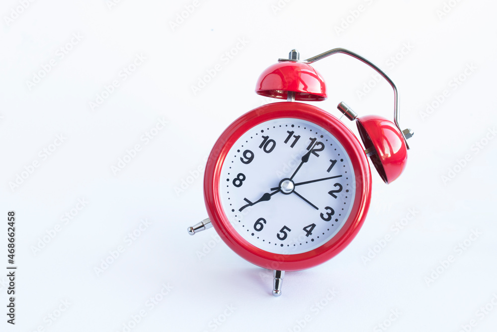 Red alarm clock on the white background. Close-up. Copy space. Red alarm clock on the white background. Close-up. Copy space.