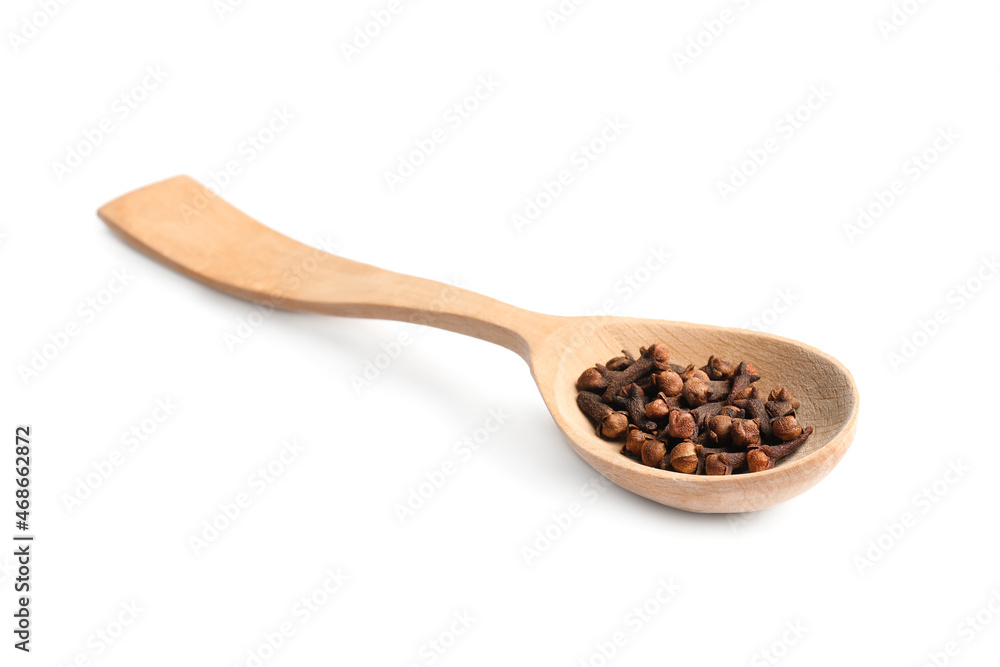 Wooden spoon with aromatic dry cloves isolated on white Wooden spoon with aromatic dry cloves isolated on white