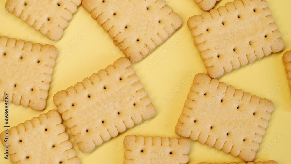 Small butter biscuits spread out on a yellow background Small butter biscuits spread out on a yellow background