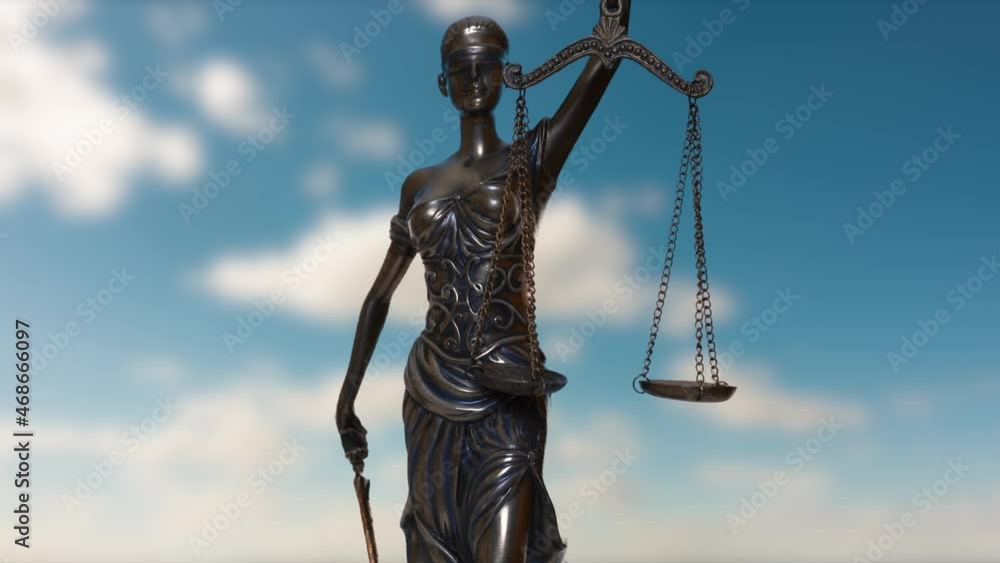 the statue of justice turns against the backdrop of clouds moving across the blue sky. the statue of justice turns against the backdrop of clouds moving across the blue sky.