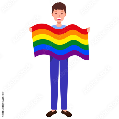 Brunette man holding big rainbow flag taking part in the pride parade.