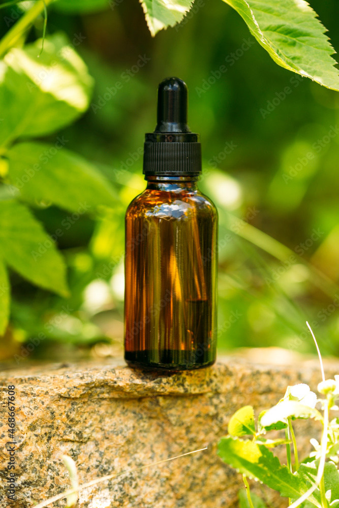 Serum in a glass bottle with a pipette. Essential oil for the care of women's skin. Skin care, moisturizing cosmetic product. Serum in a glass bottle with a pipette. Essential oil for the care of women's skin. Skin care, moisturizing cosmetic product.