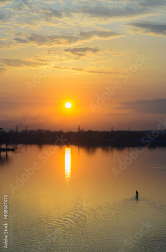 Sunset on the river Sviyaga. Silhouette of paddler in a kayak.