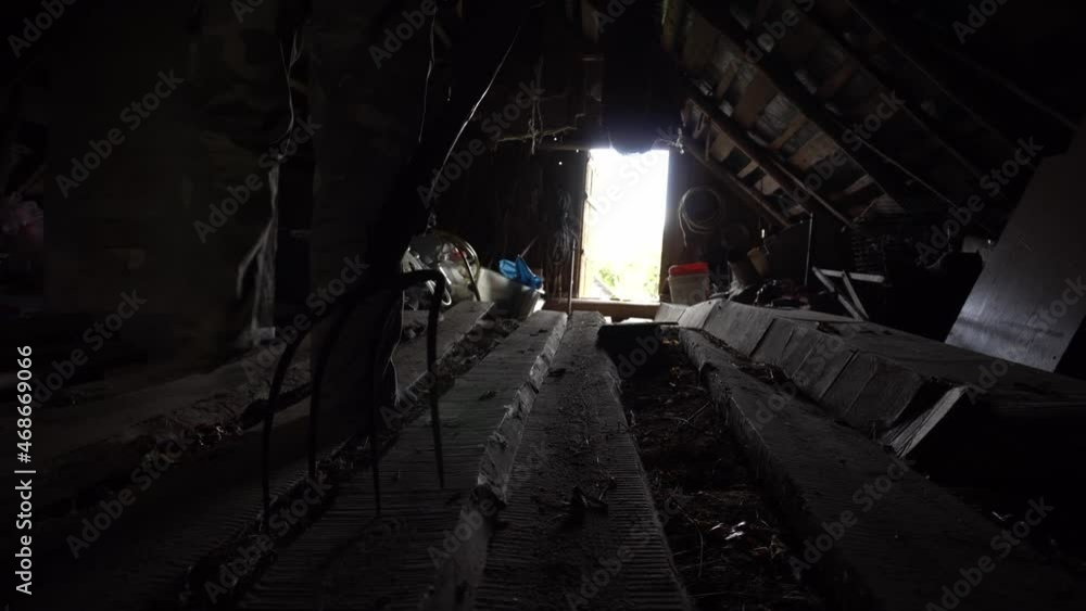 Man walks with pitchfork in a dark attic towards the exit, killer with pitchfork, horror shot for halloween, horror movie Man walks with pitchfork in a dark attic towards the exit, killer with pitchfork, horror shot for halloween, horror movie