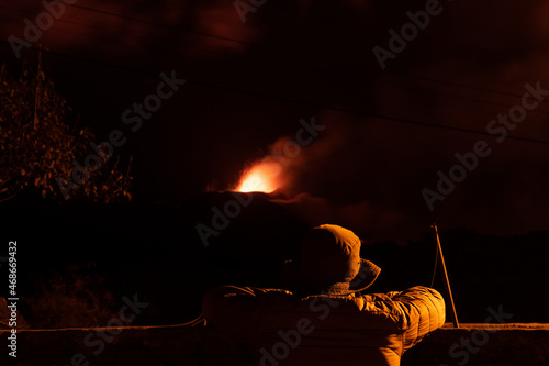 Person watching the strombolian eruption of La Palma volcano erupting. Cumbre Vieja. Canary Island. photo