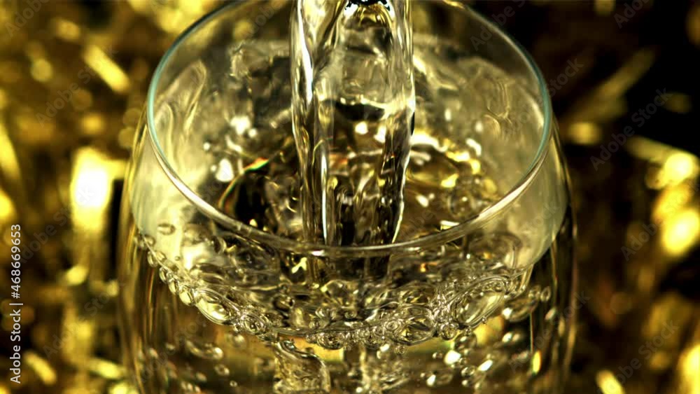 Golden champagne pours into a glass with air bubbles. On a yellow background. Filmed is slow motion 1000 frames per second. High quality FullHD footage Golden champagne pours into a glass with air bubbles. On a yellow background. Filmed is slow motion 1000 frames per second. High quality FullHD footage