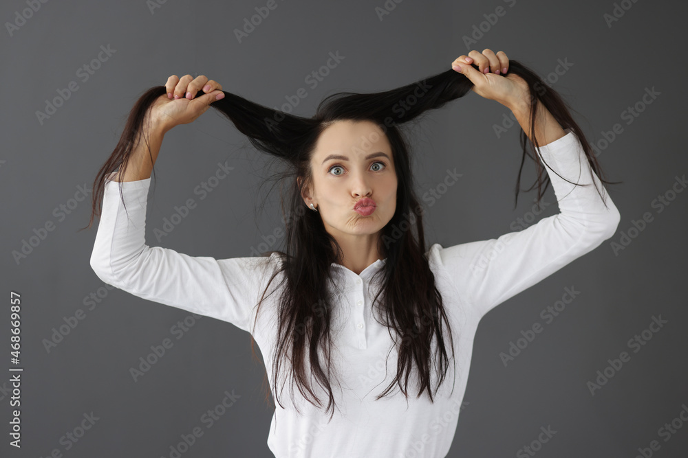 Young woman fooling around and holding her hair Young woman fooling around and holding her hair