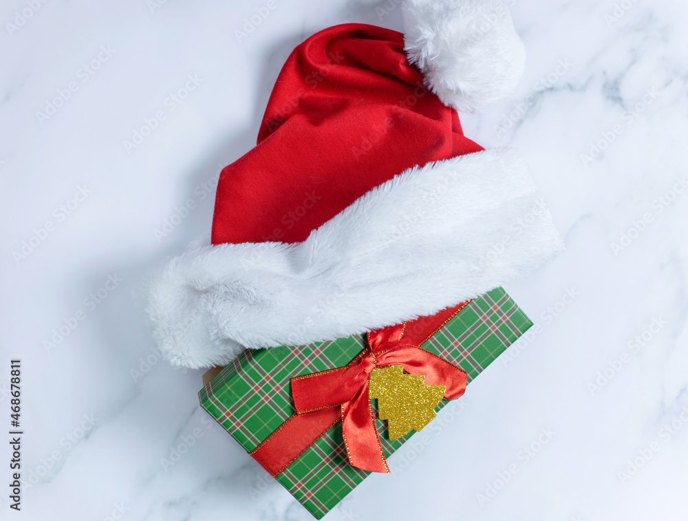 Christmas gift boxes with Santa Claus hat on white background Christmas gift boxes with Santa Claus hat on white background