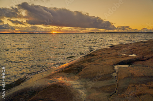 The rocky coast of the Baltic Sea at sunset. photo