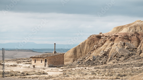 Old sheepfold at Bardenas Reales semi-desert under a blue cloudy surrounded by rock formations