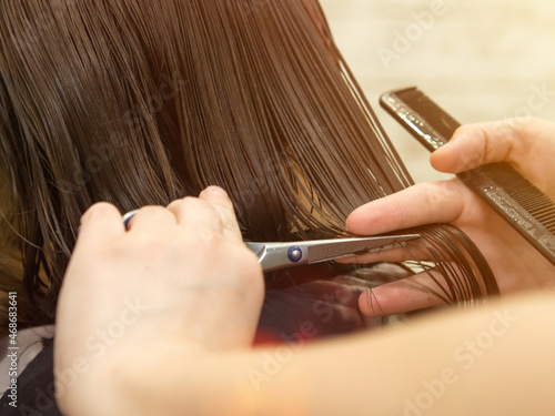 Hairdresser trimming hair with scissors. Haircut closeup. Getting rid of those split ends