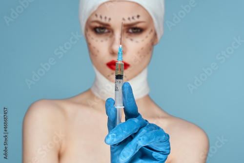 female patient in blue gloves syringe in hands contour on the face lifting studio lifestyle