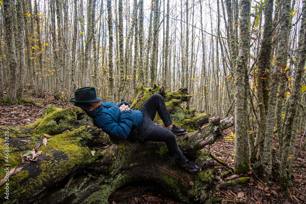 Ecuadorian Otavaleño indigenous man from South America resting in nature.