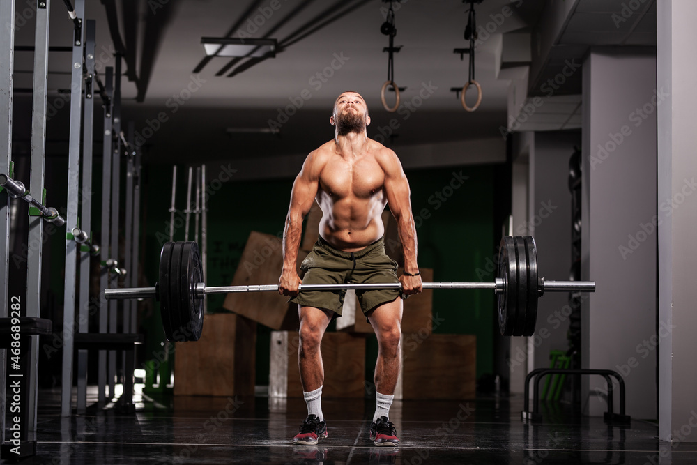 Muscular athlete lifting very heavy barbell Muscular athlete lifting very heavy barbell