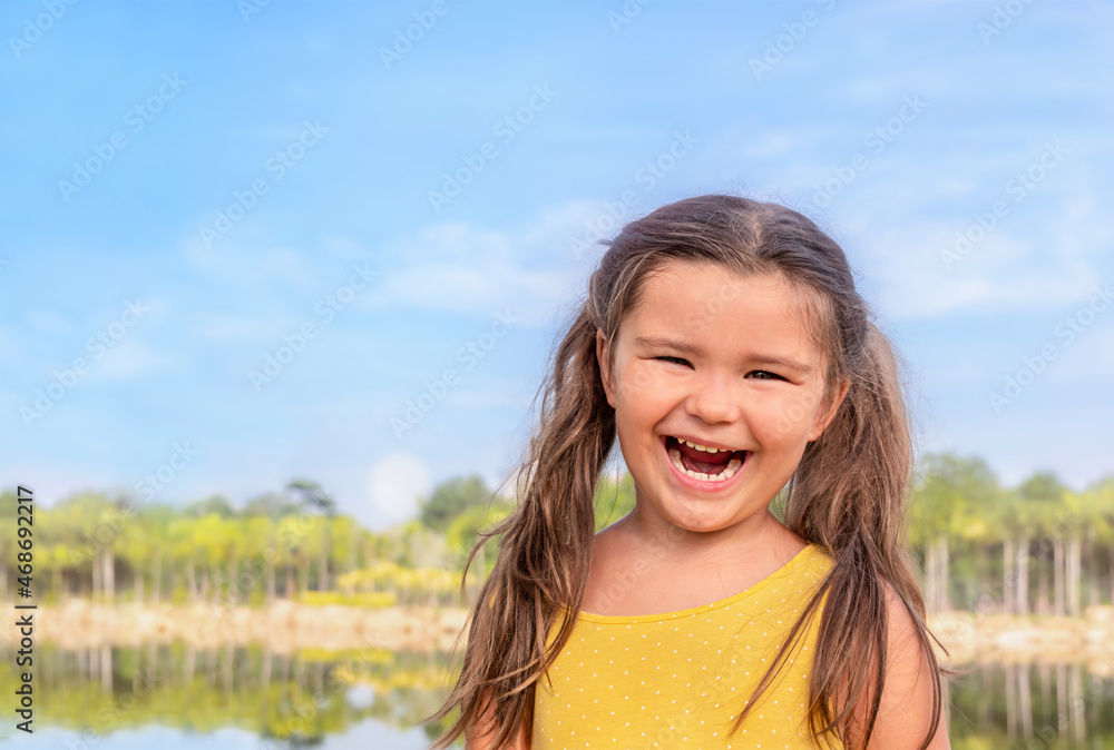 Portrait of a happy child near the lake Portrait of a happy child near the lake