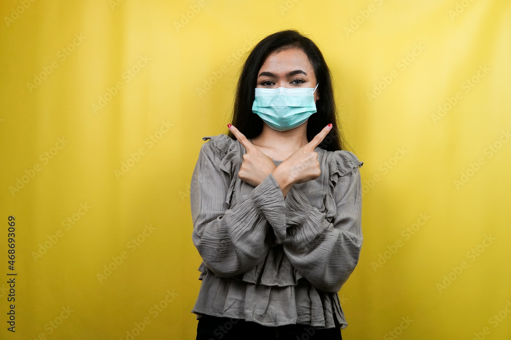 Beautiful young woman wearing a mask with hands pointing at empty space, presenting something, isolated Beautiful young woman wearing a mask with hands pointing at empty space, presenting something, isolated