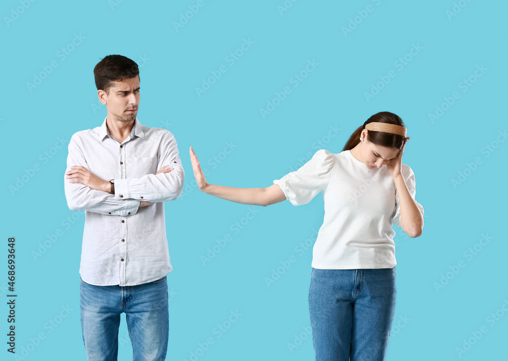 Quarreled young couple on blue background Quarreled young couple on blue background