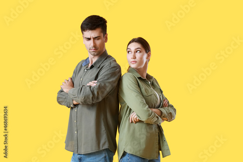 Upset young couple on yello...
