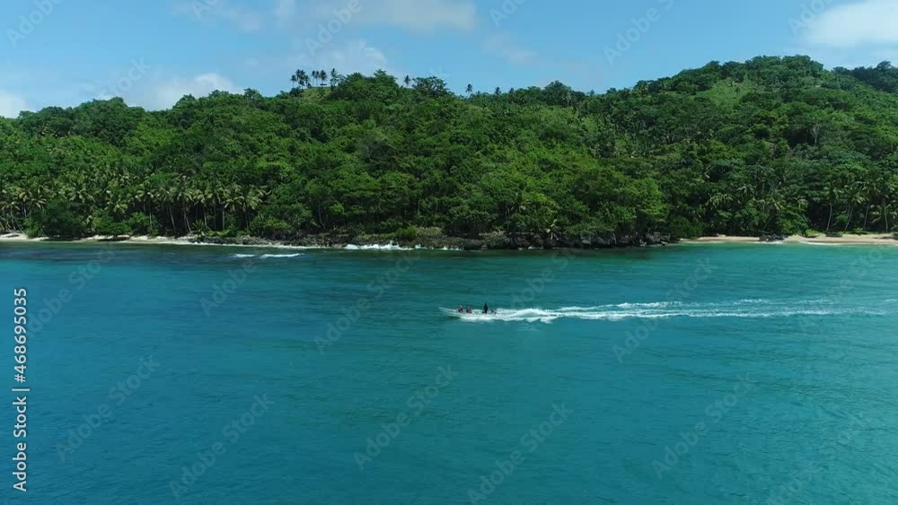 Boating At Playa Colorado - People On Boat Sailing In Blue Sea Leaving Wake On Water Surface In Dominican Republic