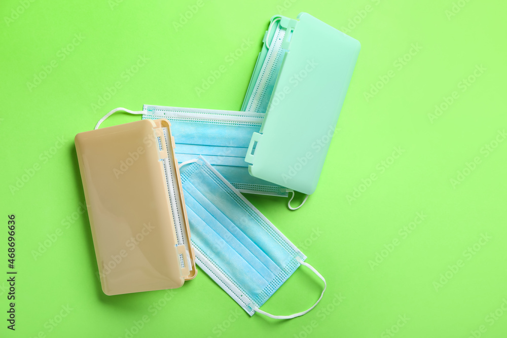 Medical masks with cases on green background Medical masks with cases on green background