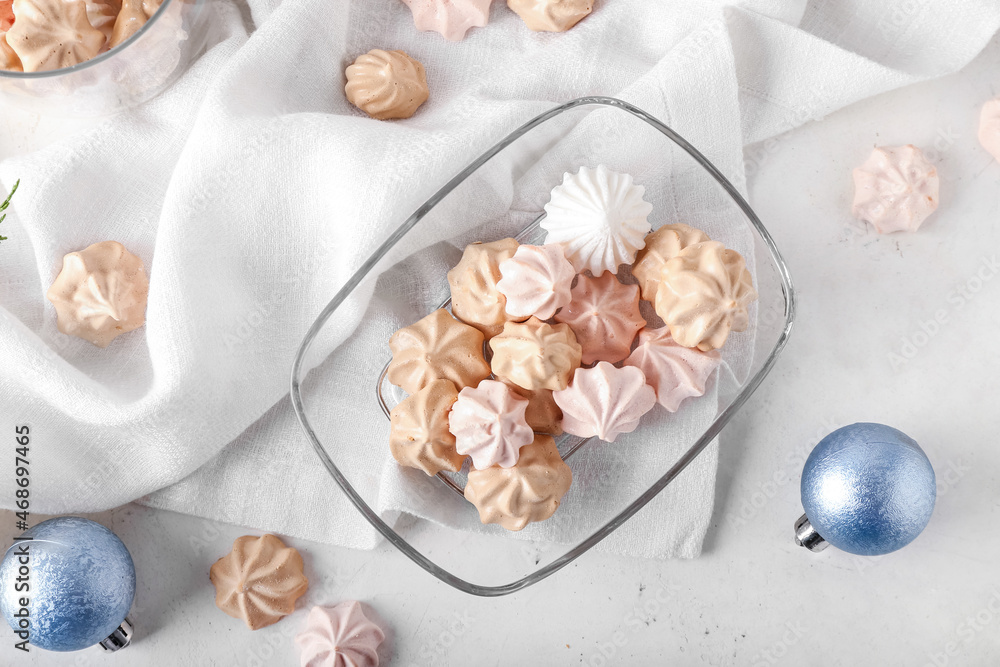 Glass bowl with tasty meringues on white background Glass bowl with tasty meringues on white background
