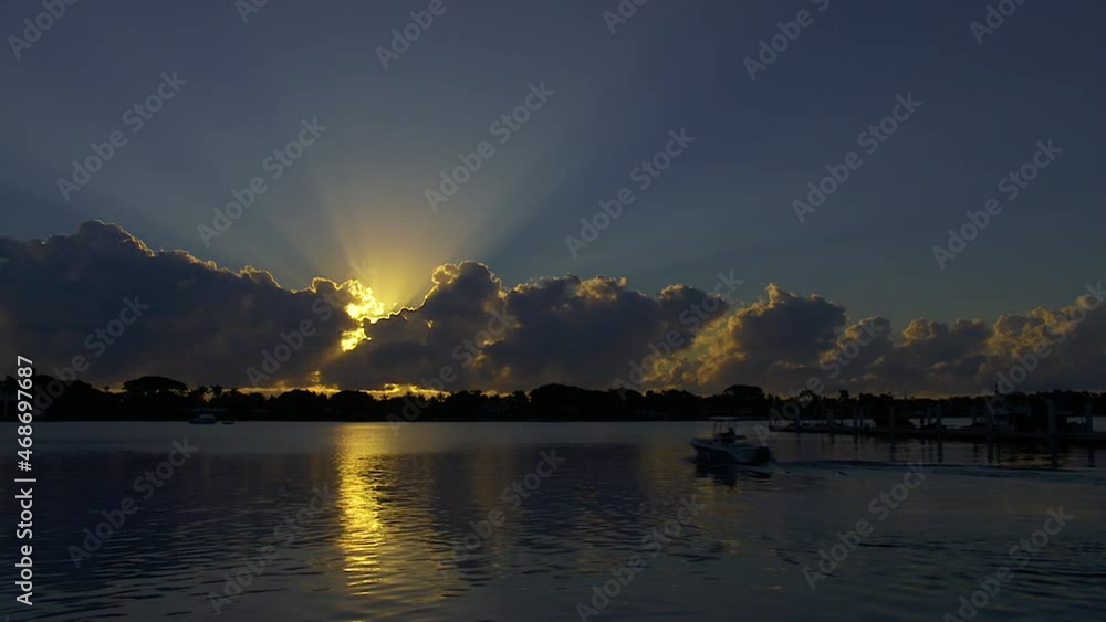 Small Motor Boat Leaves From Dock At Sunrise In South Florida, U.S.A. Small Motor Boat Leaves From Dock At Sunrise In South Florida, U.S.A.