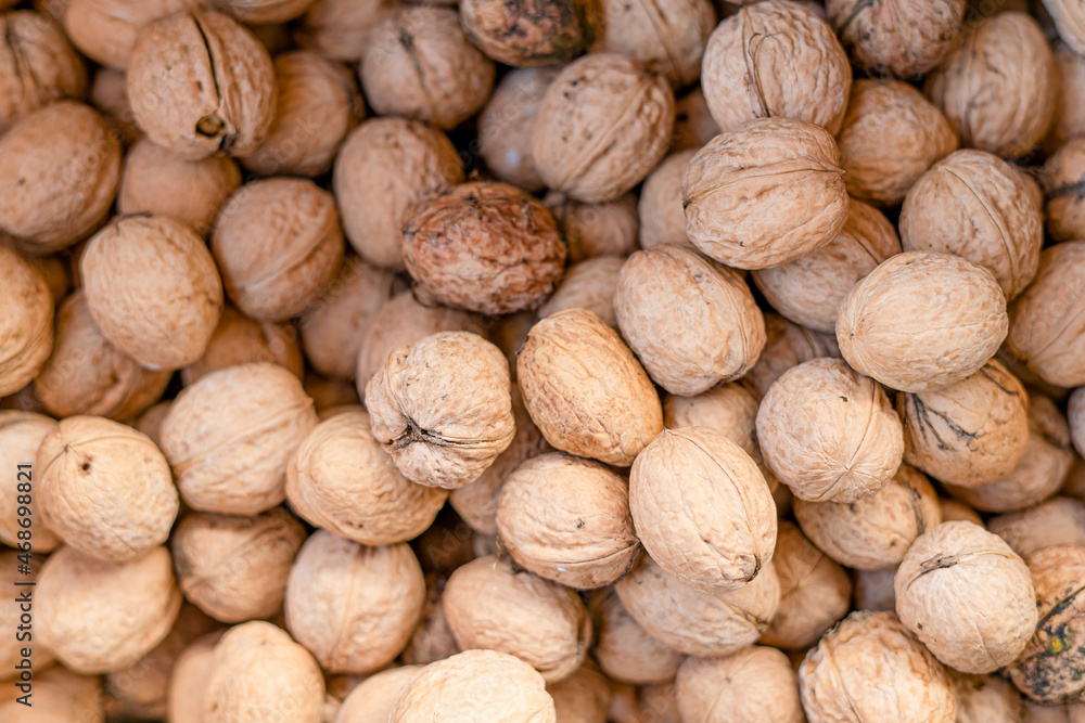 Walnuts lie in a box close-up. Walnut shell Walnuts lie in a box close-up. Walnut shell