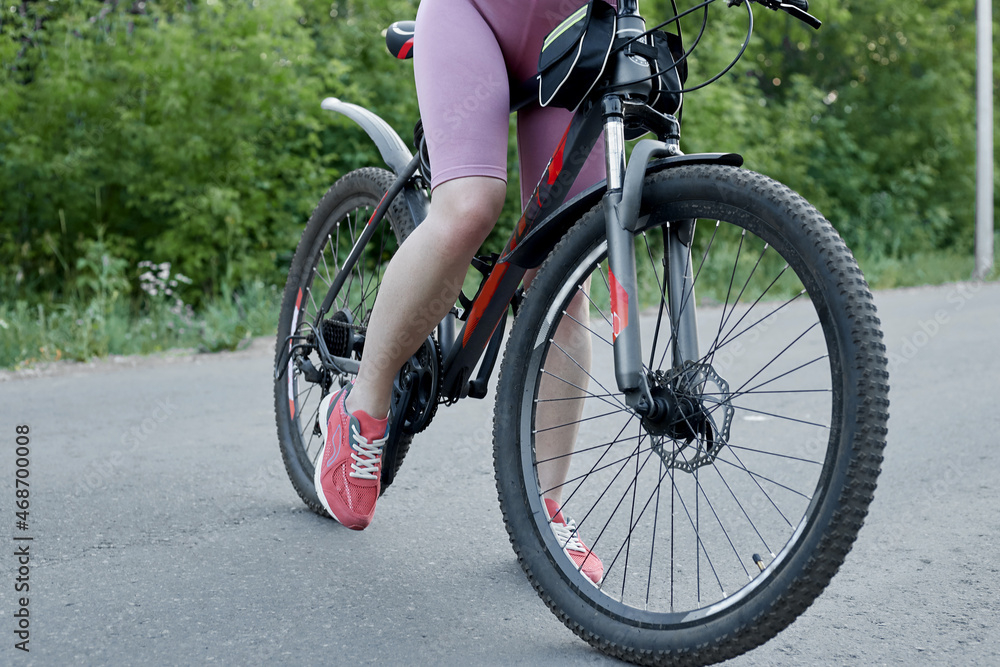 A sporty girl with a bicycle concept: an active and healthy lifestyle A sporty girl with a bicycle concept: an active and healthy lifestyle